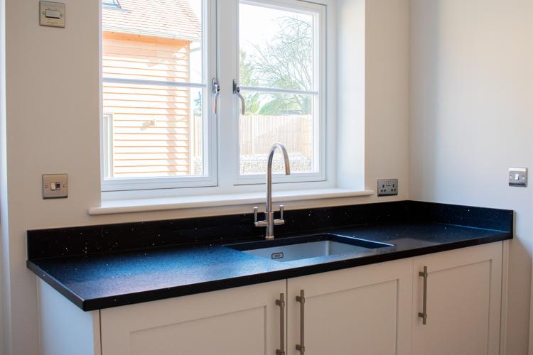 Global Black Mirror Quartz Worktops in Utility Room