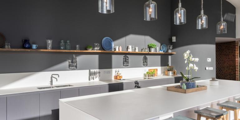 dark grey kitchen with white worktops