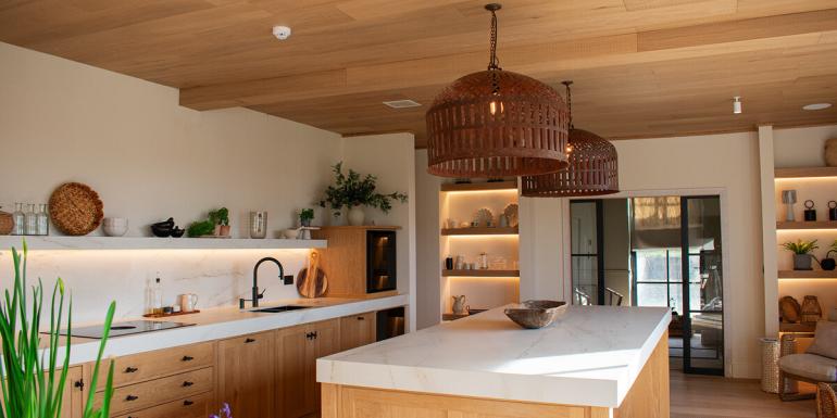 kitchen with white worktops and wooden ceiling and other furnishings