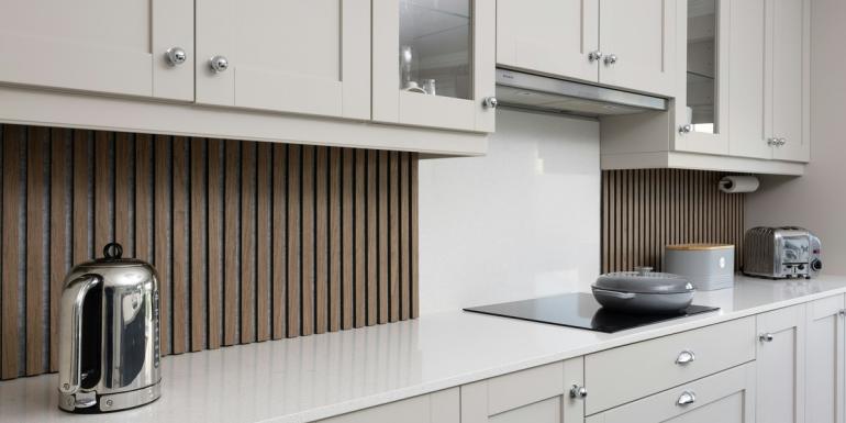 a kitchen with white cabinets and a stove top oven