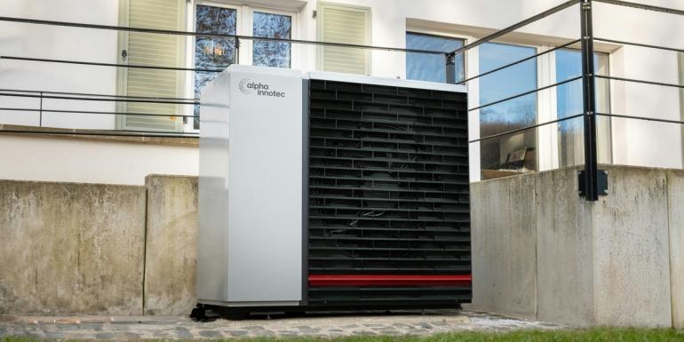 white heat pump outside a white building